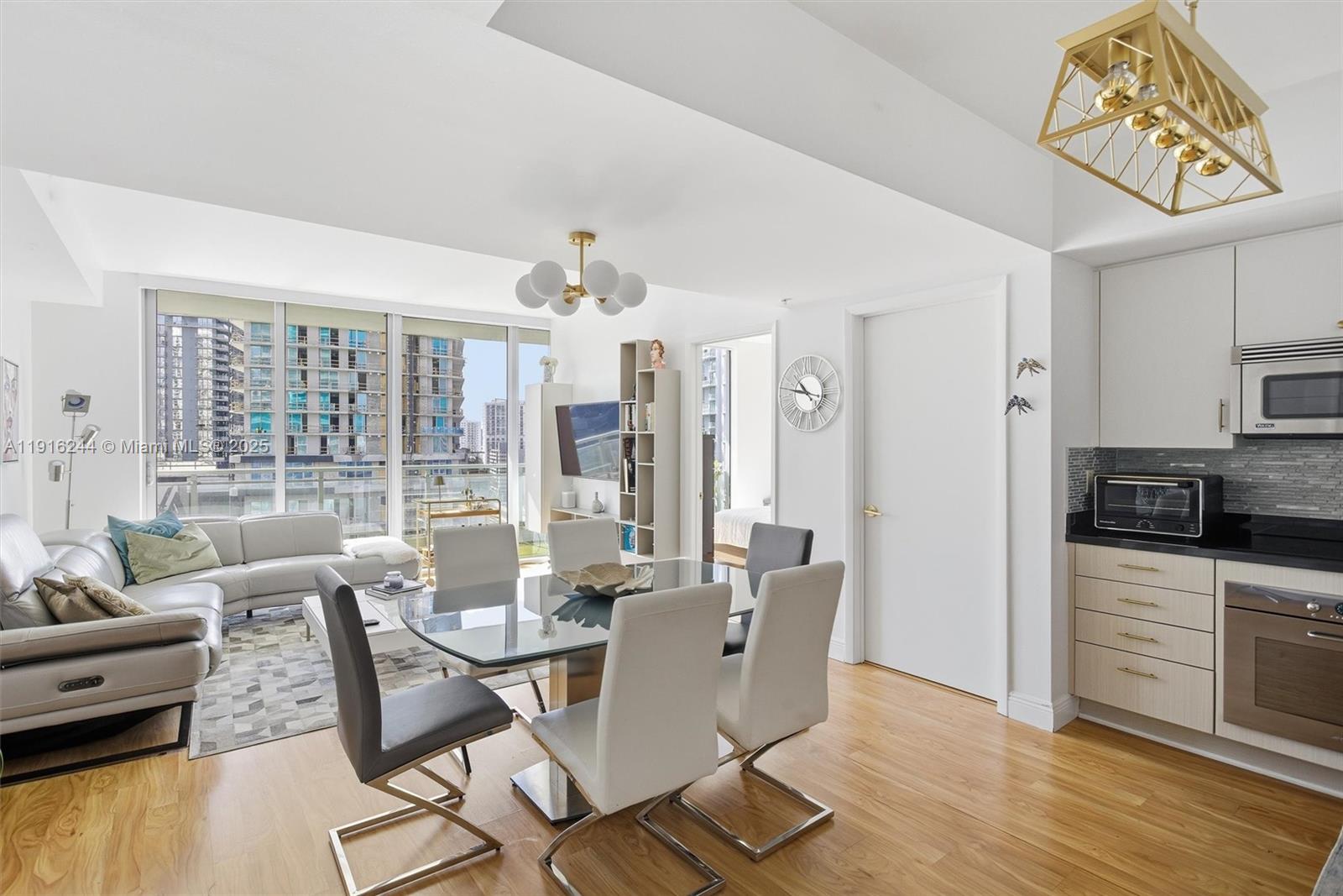 92 Southwest 3rd Street, Unit 1604 Miami, FL 33130 - Photo 9 of 53 a view of a dining room with furniture window and wooden floor
