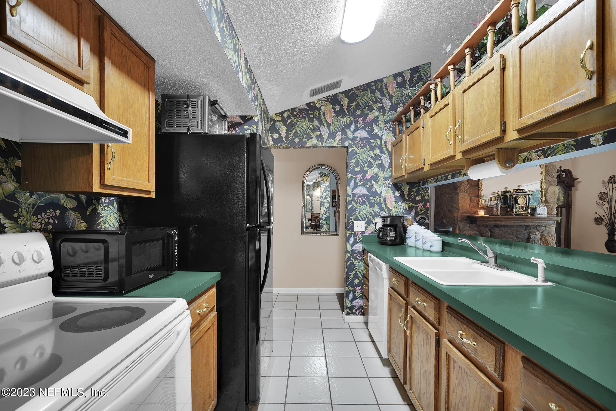 10250 Lake Pines Road Jacksonville, FL 32257 - Photo 12 of 24 a kitchen with stainless steel appliances granite countertop a sink and a refrigerator