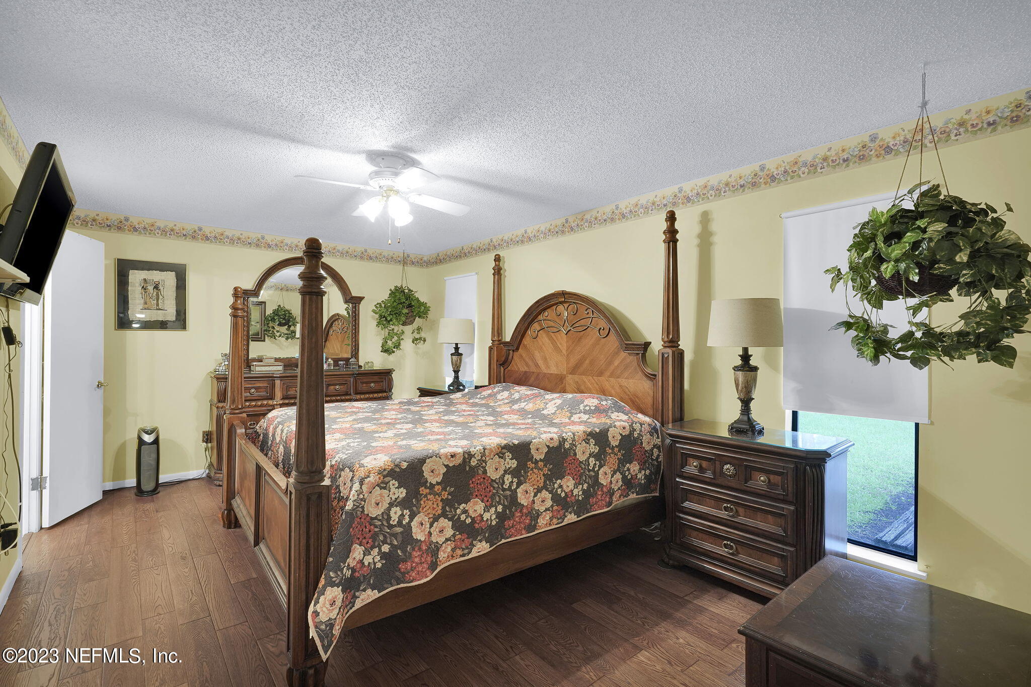 10250 Lake Pines Road Jacksonville, FL 32257 - Photo 15 of 24 a bedroom with a bed table closet and a flat tv screen