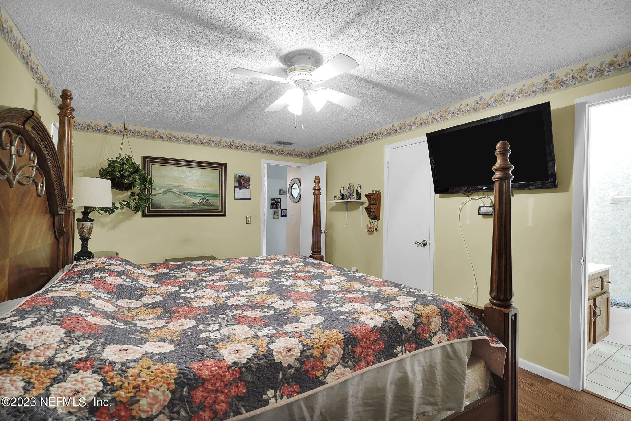 10250 Lake Pines Road Jacksonville, FL 32257 - Photo 16 of 24 a bedroom with a large bed and a flat screen tv
