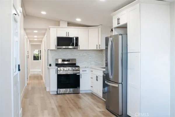 a kitchen with stainless steel appliances a refrigerator stove and microwave