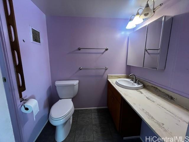 1615 Wilder Avenue, Unit 607 Honolulu, HI 96822 - Photo 12 of 19 a bathroom with a granite countertop toilet sink and mirror