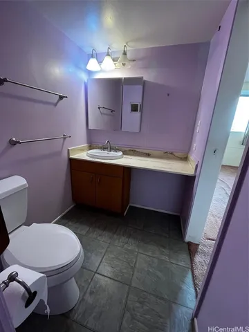 a white toilet sitting next to a bathroom sink