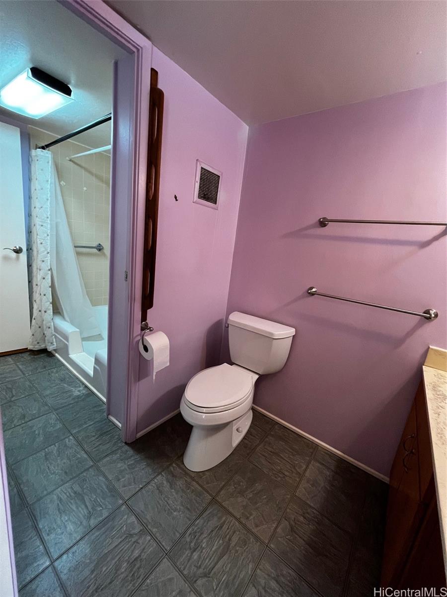 1615 Wilder Avenue, Unit 607 Honolulu, HI 96822 - Photo 14 of 19 a white toilet sitting next to a bathroom sink
