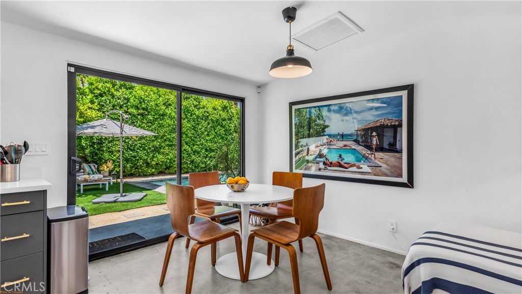 250 West Cortez Road Palm Springs, CA 92262 - Photo 11 of 54 a dining room with furniture a flat screen tv and a large window