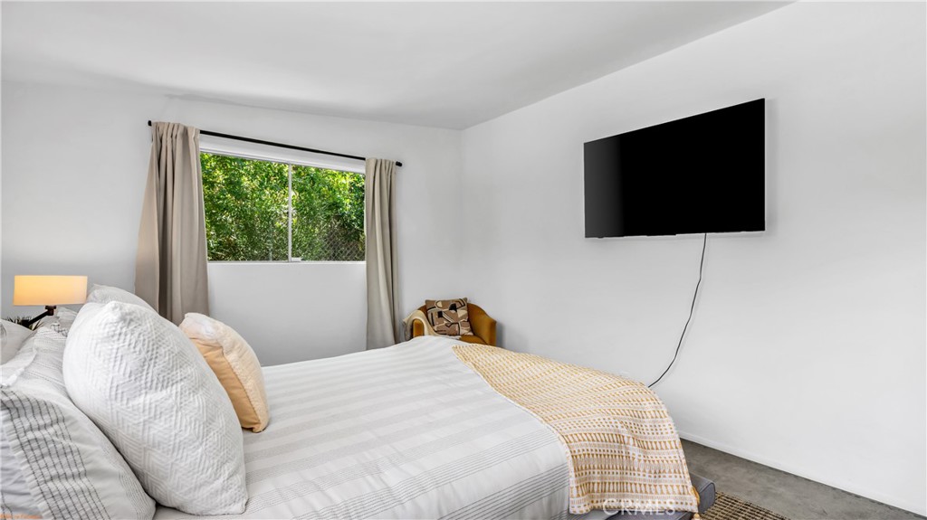 250 West Cortez Road Palm Springs, CA 92262 - Photo 20 of 54 a bedroom with a bed and a flat screen tv