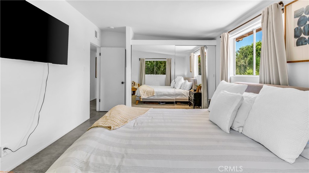 250 West Cortez Road Palm Springs, CA 92262 - Photo 21 of 54 a bedroom with a bed and a flat screen tv