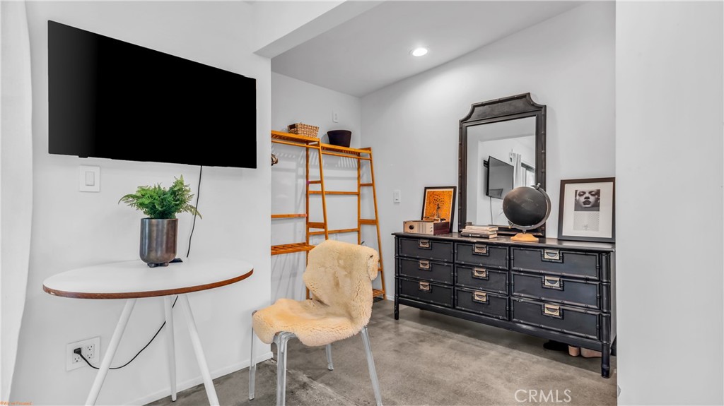 250 West Cortez Road Palm Springs, CA 92262 - Photo 30 of 54 a living room with furniture a flat screen tv and a potted plant