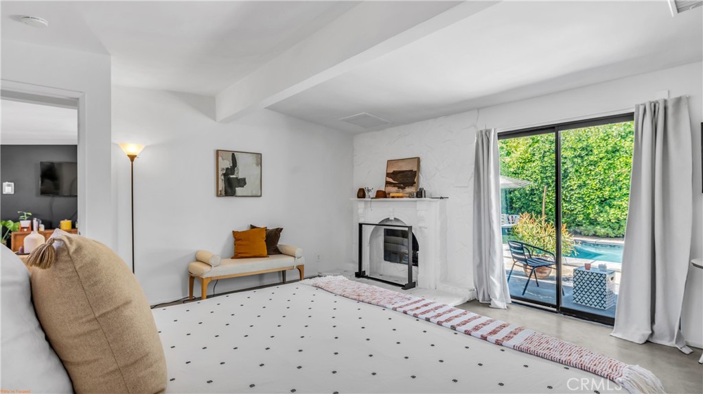 250 West Cortez Road Palm Springs, CA 92262 - Photo 31 of 54 a bedroom with furniture and a fireplace