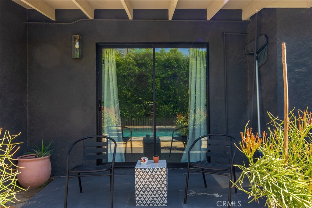 250 West Cortez Road Palm Springs, CA 92262 - Photo 39 of 54 a view of a patio with table and chairs and potted plants