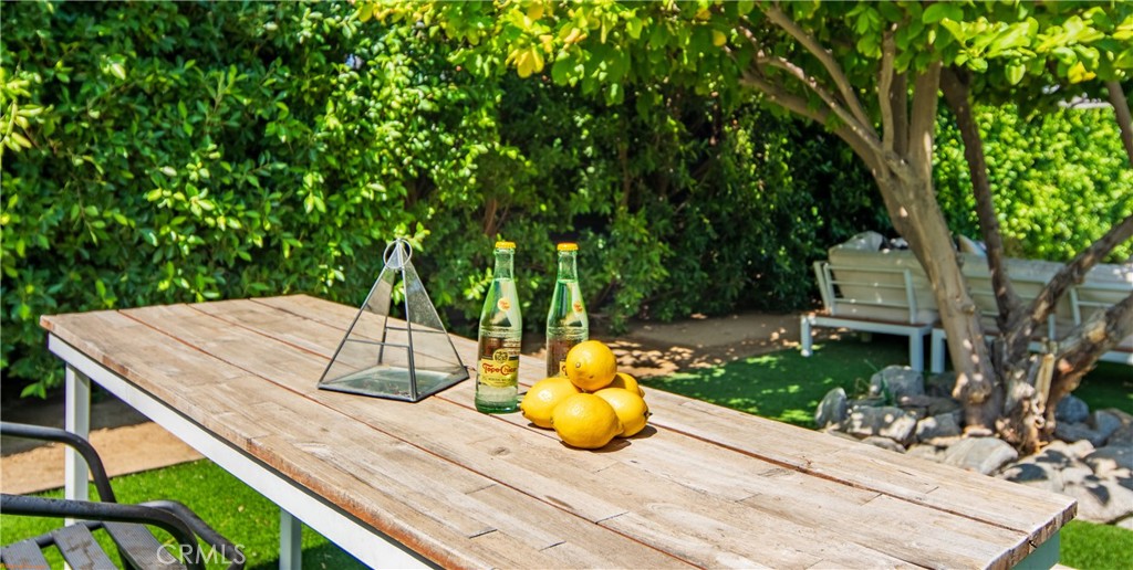 250 West Cortez Road Palm Springs, CA 92262 - Photo 42 of 54 a view of a patio with table and chairs potted plants and large tree