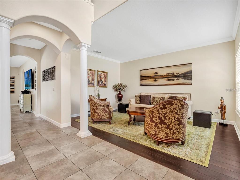 10023 Ians Ridge Road Orlando, FL 32832 - Photo 9 of 60 a living room with furniture a rug and a fireplace
