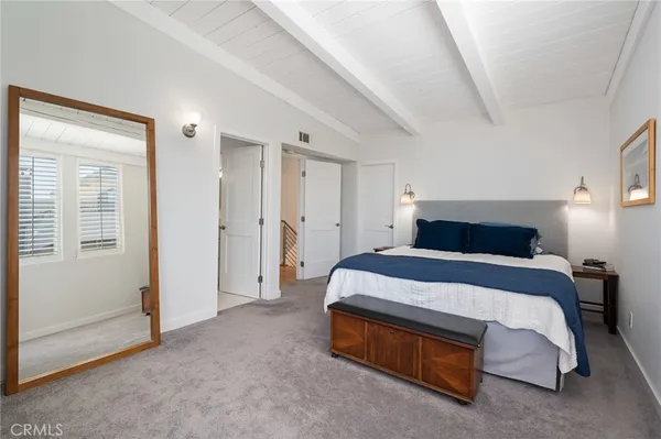 an empty room with windows cabinet and flat screen tv