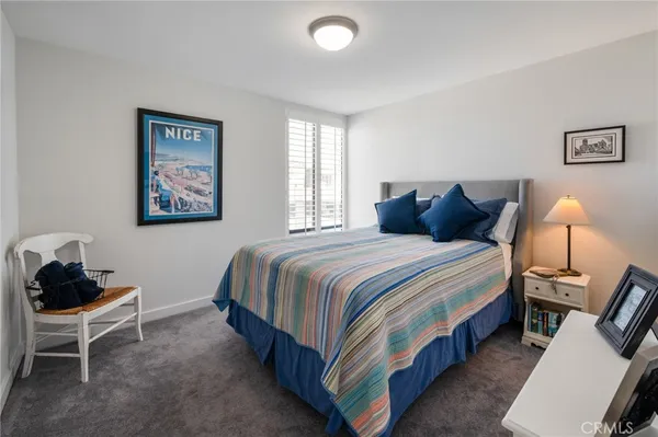a bedroom with bed and wooden floor