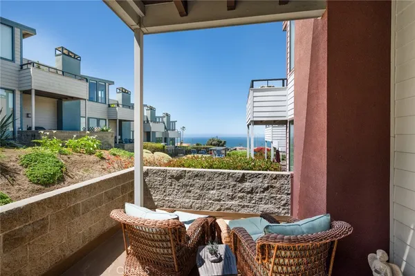 a view of roof deck with two couches and a potted plant