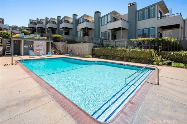 a view of a rooftop deck and patio with swimming pool