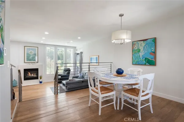 a kitchen with a dining table chairs refrigerator and microwave