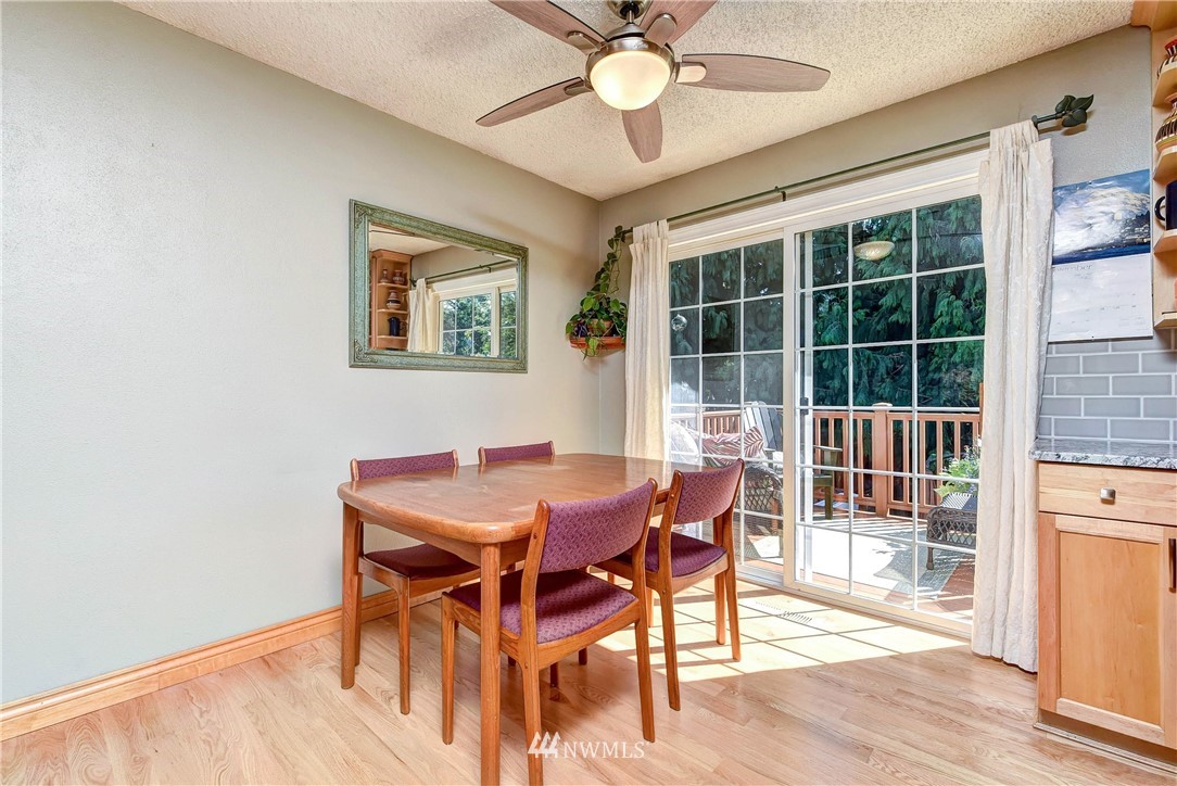 110 217th Place Southeast Bothell, WA 98021 - Photo 11 of 32 a view of a dining room with furniture window and wooden floor