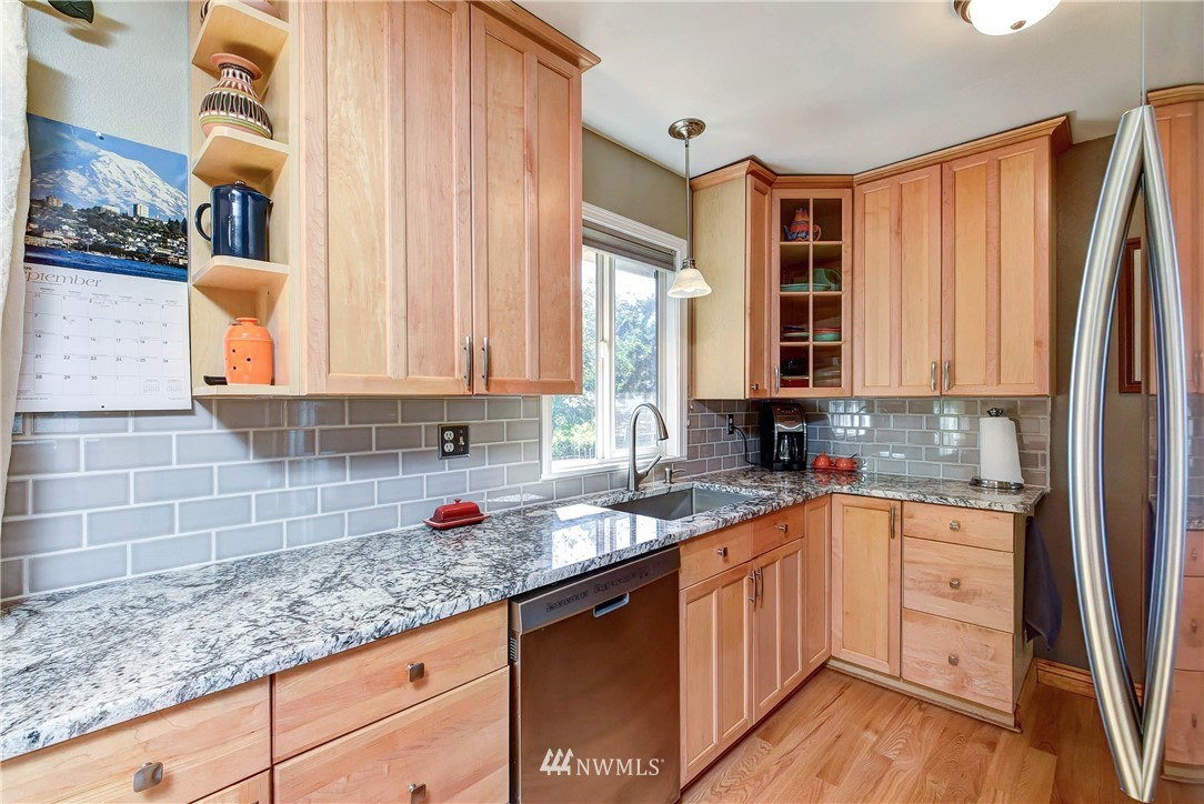 110 217th Place Southeast Bothell, WA 98021 - Photo 12 of 32 a kitchen with stainless steel appliances granite countertop a sink a stove and cabinets