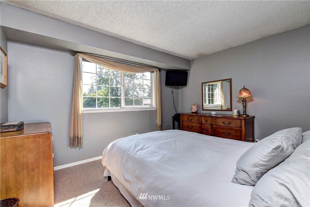 110 217th Place Southeast Bothell, WA 98021 - Photo 15 of 32 a bedroom with a bed and wooden floor