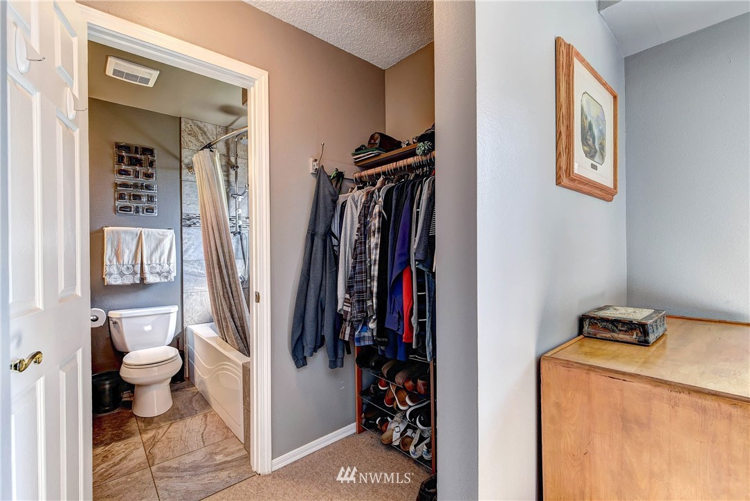 110 217th Place Southeast Bothell, WA 98021 - Photo 16 of 32 a view of walk in closet with clothes and shoes