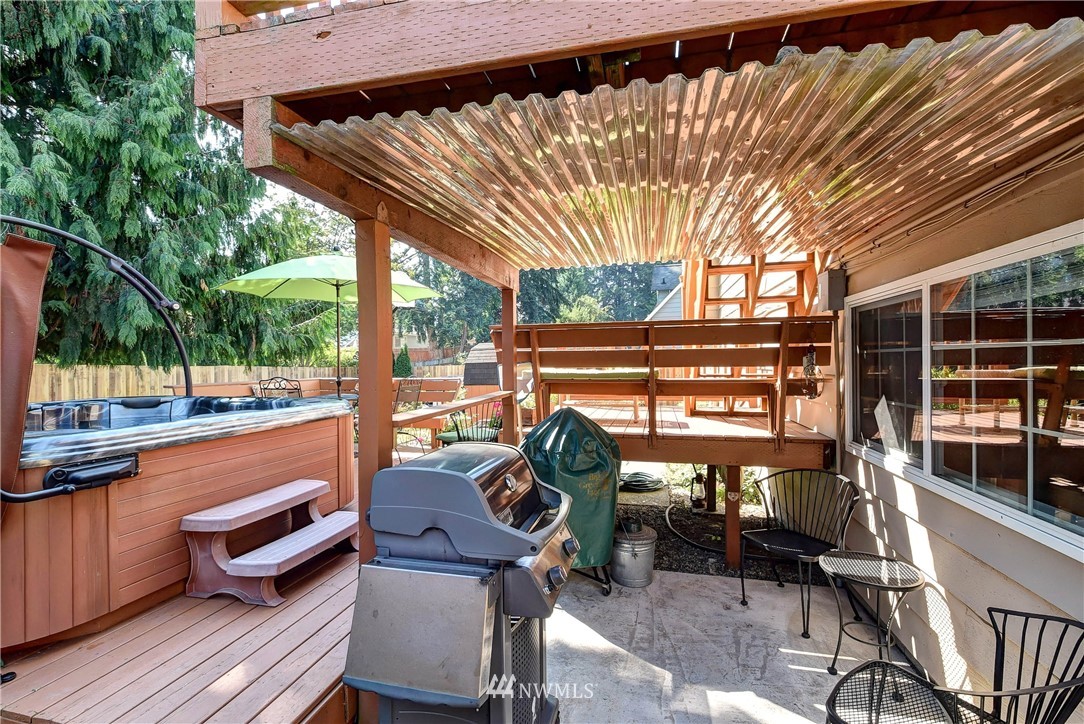 110 217th Place Southeast Bothell, WA 98021 - Photo 29 of 32 a view of a patio with a table chairs and a backyard