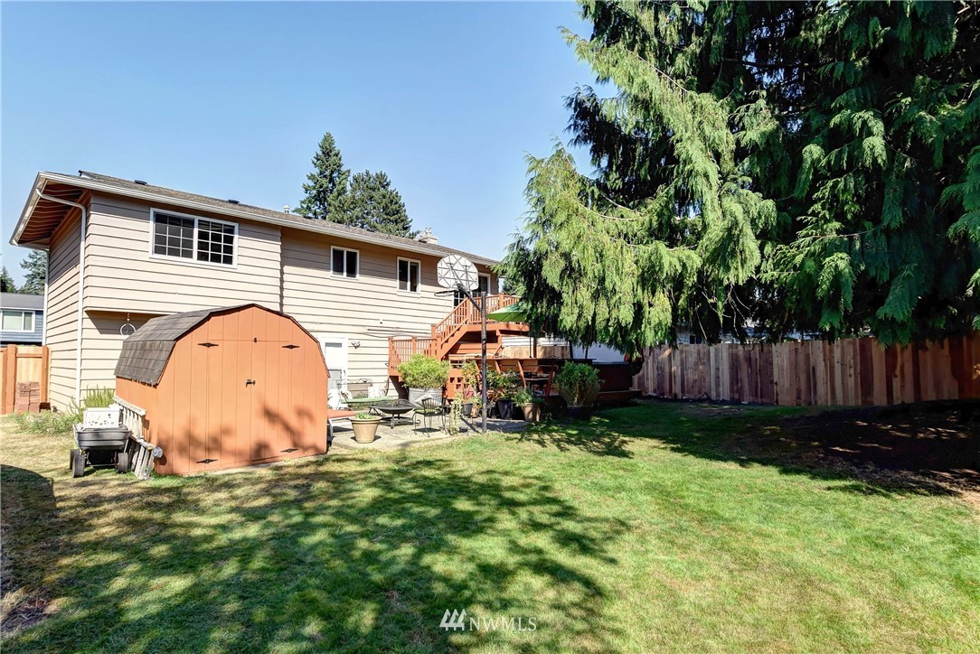 110 217th Place Southeast Bothell, WA 98021 - Photo 30 of 32 a backyard of a house with table and chairs