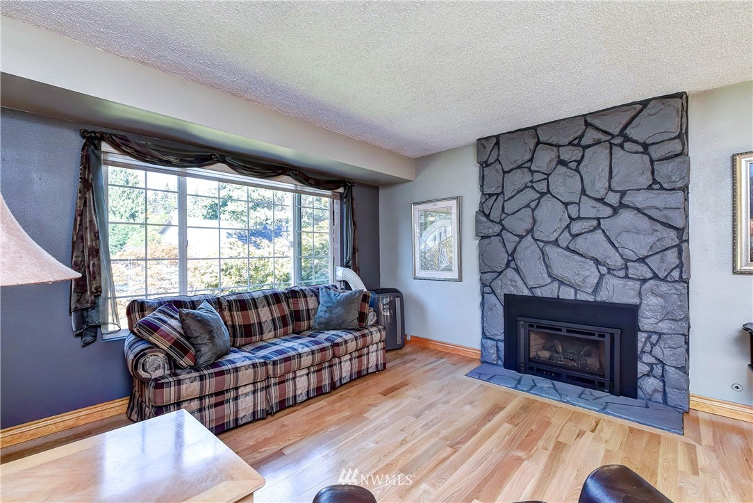 110 217th Place Southeast Bothell, WA 98021 - Photo 10 of 32 a living room with furniture and a fireplace