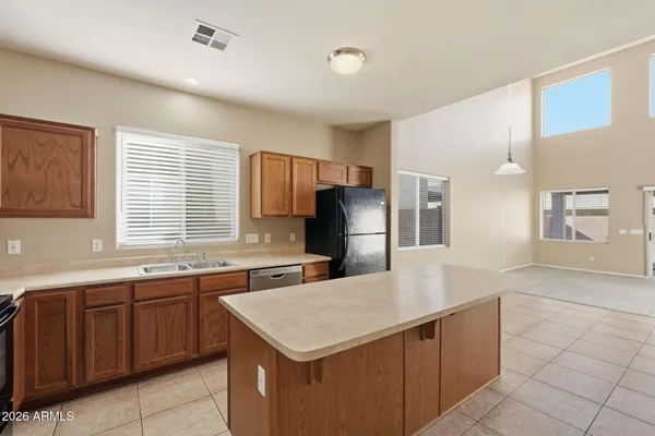 a kitchen with stainless steel appliances a stove a microwave and white cabinets