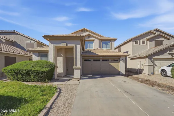 a front view of a house with a yard and garage