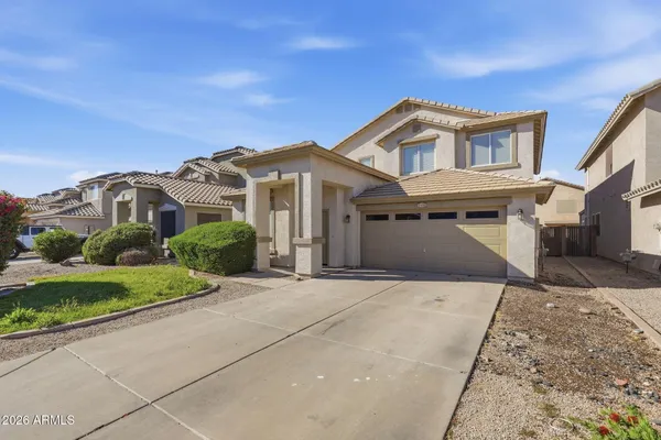 a front view of a house with a garden and mountain view