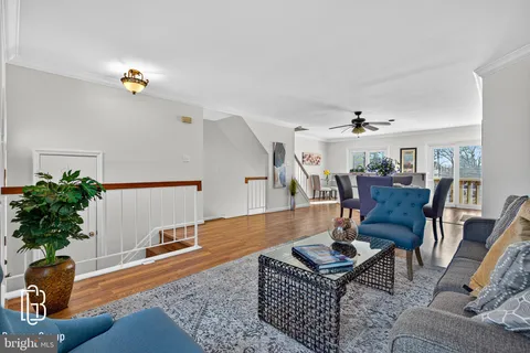 a living room with dining room and wooden floor
