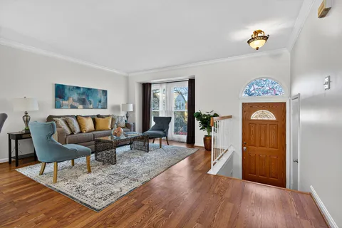 a living room with furniture and wooden floor