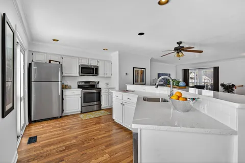 a bathroom with a granite countertop sink mirror vanity and toilet
