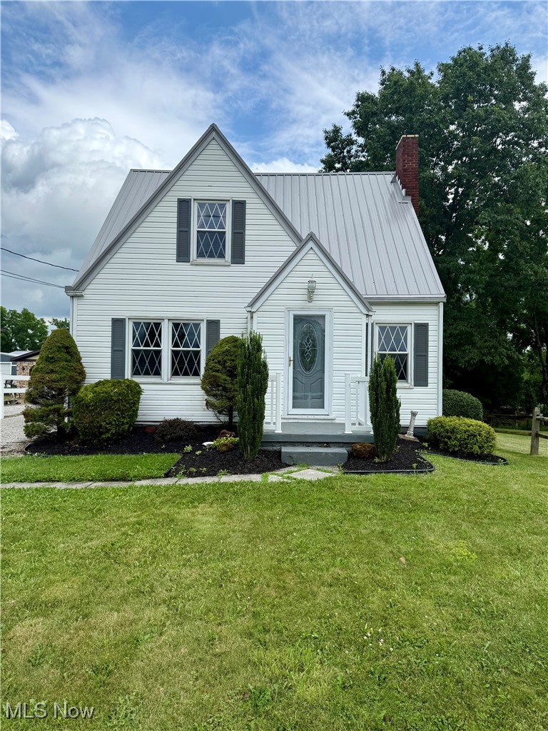 2614 Eldersville Road Follansbee, WV 26037 - Photo 2 of 18 View of front of property with a chimney, a front yard, and a metal roof