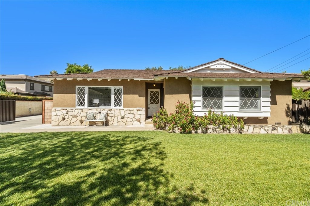 a front view of a house with a garden