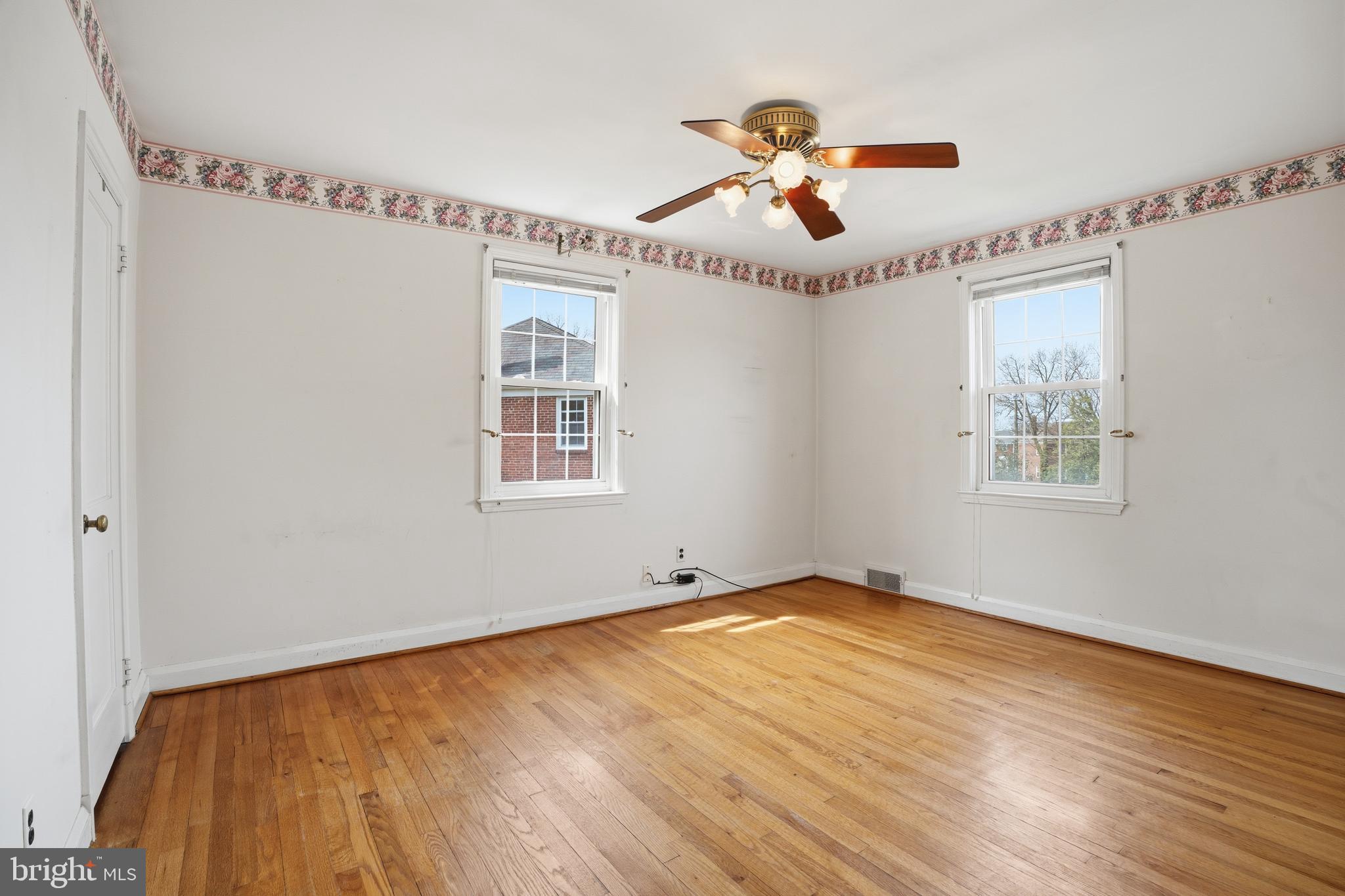 123 Glen Argyle Road Baltimore, MD 21212 - Photo 15 of 33 a view of empty room with wooden floor and fan