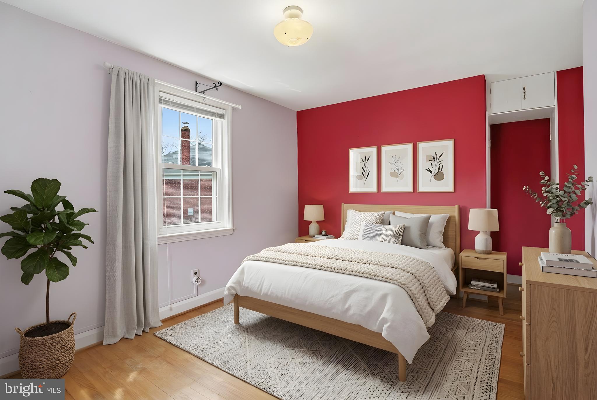 123 Glen Argyle Road Baltimore, MD 21212 - Photo 17 of 33 a bedroom with a bed and a potted plant