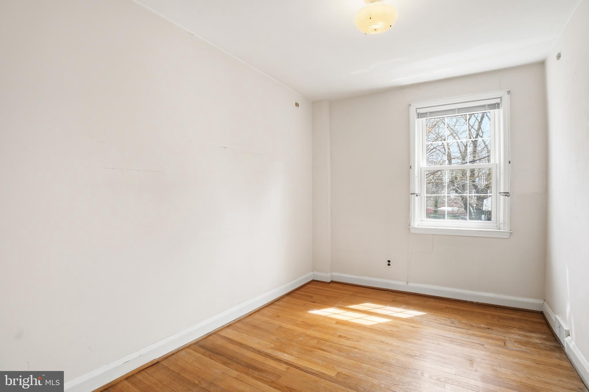 123 Glen Argyle Road Baltimore, MD 21212 - Photo 22 of 33 a view of empty room with wooden floor and fan