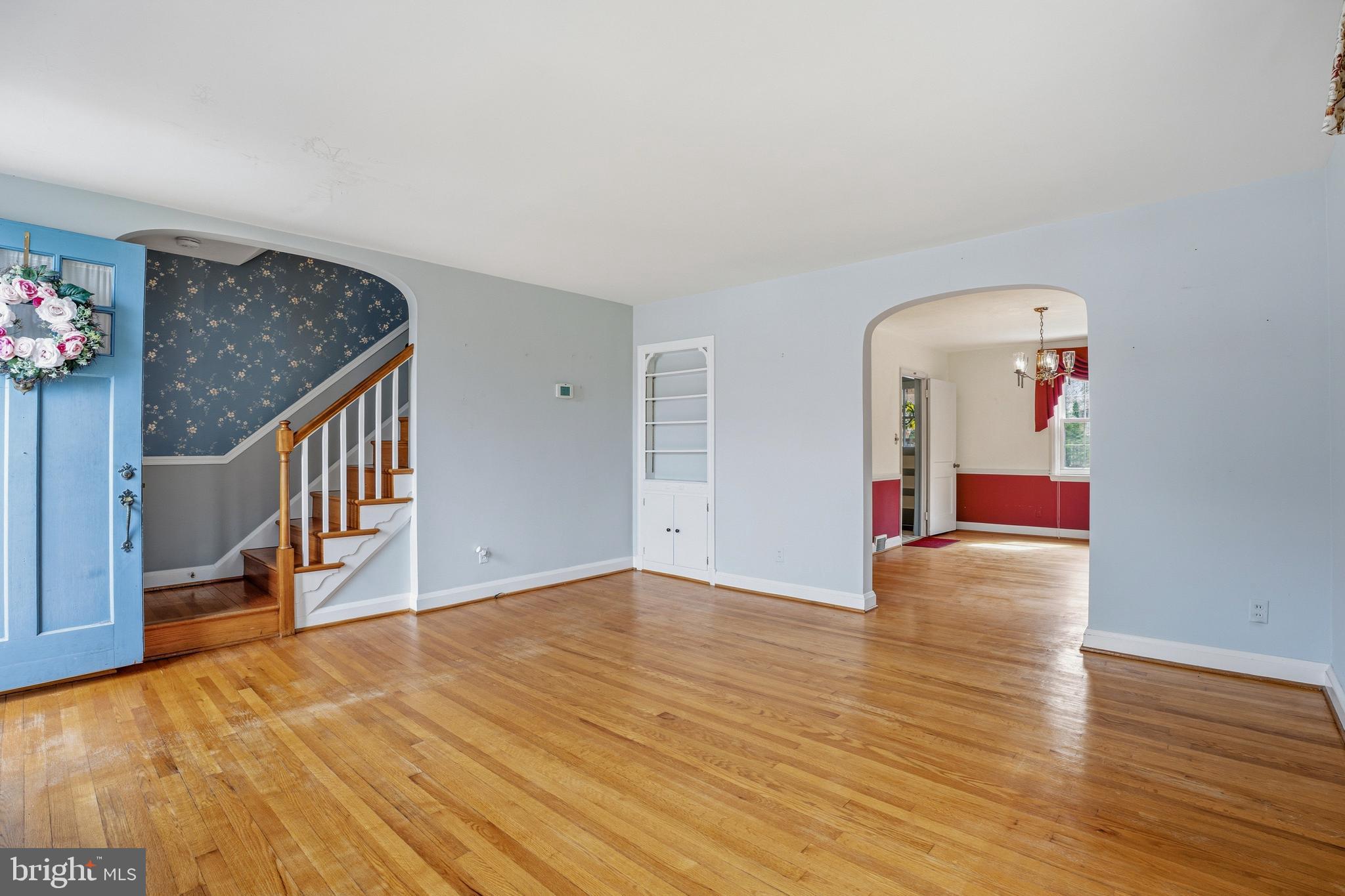 123 Glen Argyle Road Baltimore, MD 21212 - Photo 5 of 33 a view of an empty room with wooden floor and a chandelier