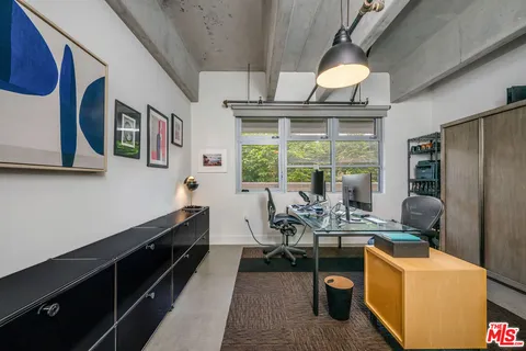 a dining room with furniture a chandelier and wooden floor