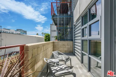 a balcony view with couple of chairs