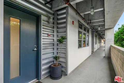 a view of a house with potted plants