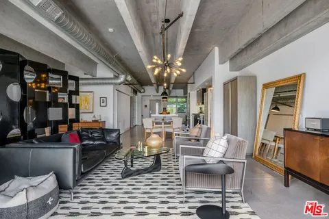 a living room with fireplace furniture and a chandelier