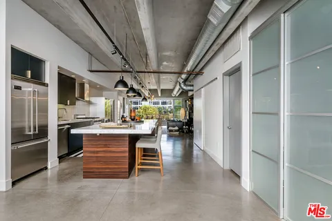 a view of kitchen with furniture and refrigerator
