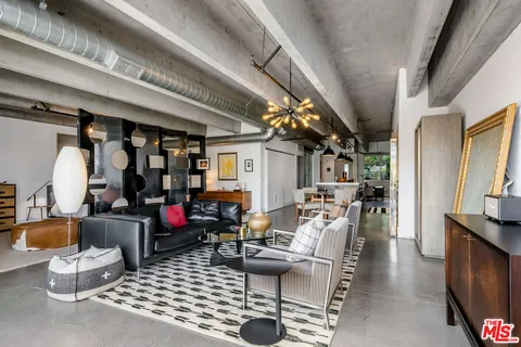 a living room with furniture a rug and a chandelier