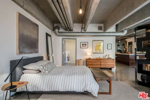 a bedroom with furniture and a flat screen tv