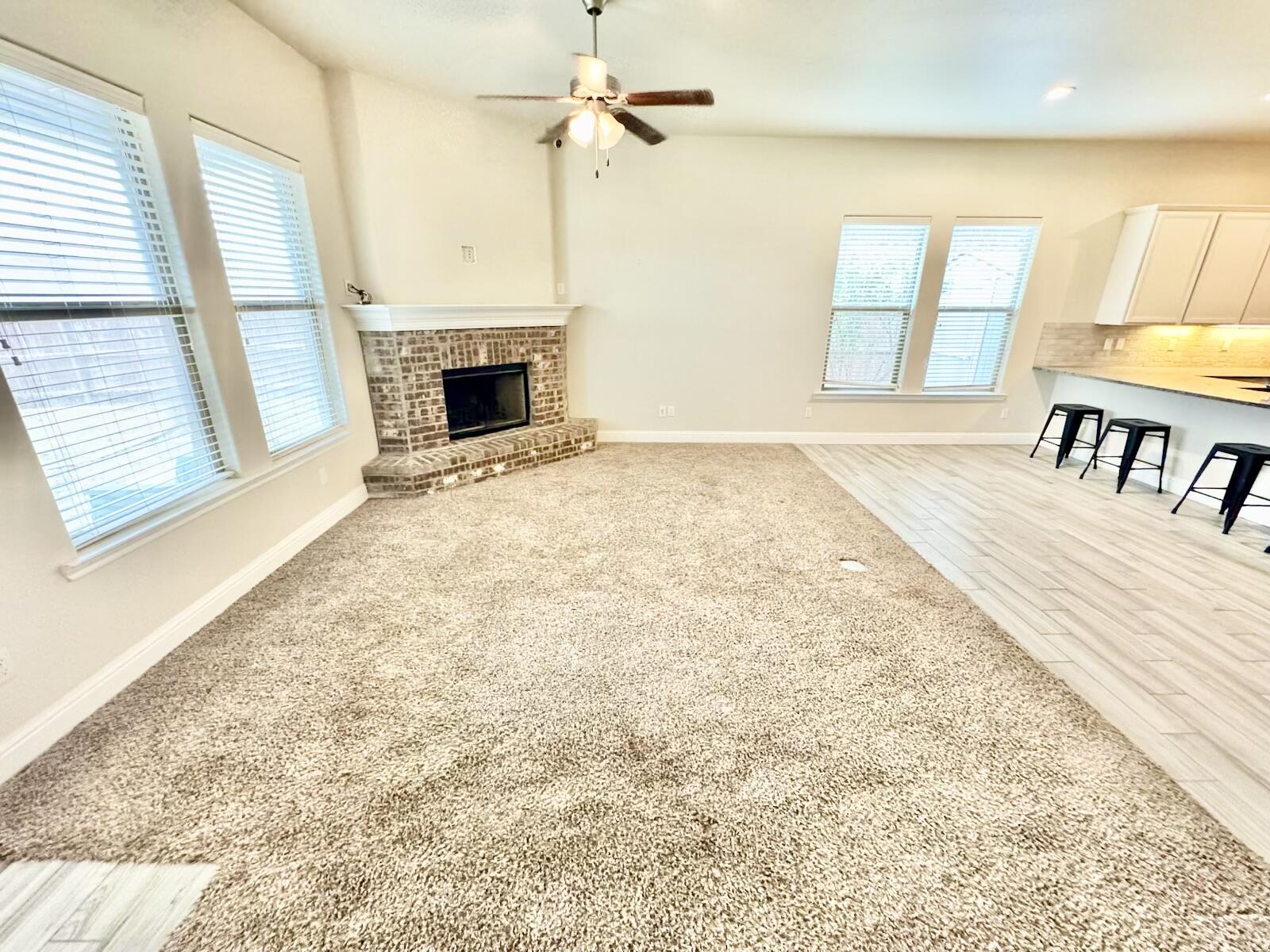 13801 Avenue West Lubbock, TX 79423 - Photo 15 of 17 an empty room with windows and fireplace