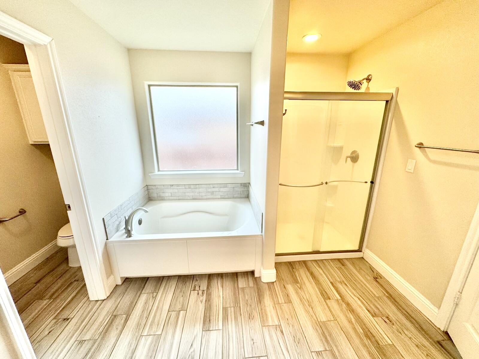 13801 Avenue West Lubbock, TX 79423 - Photo 10 of 17 a bathroom with a bathtub and a shower