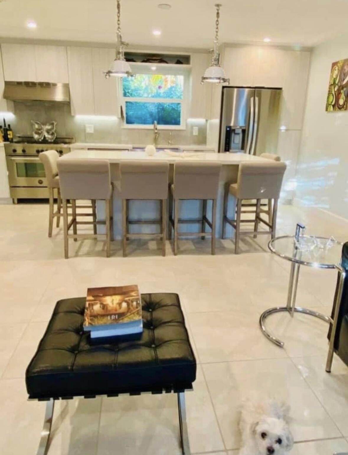 2635 Koehns Avenue Big Pine Key, FL 33043 - Photo 6 of 13 a kitchen with stainless steel appliances kitchen island granite countertop a table chairs and a refrigerator